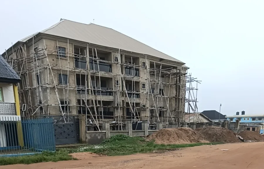 A concrete building under construction behind scaffolding